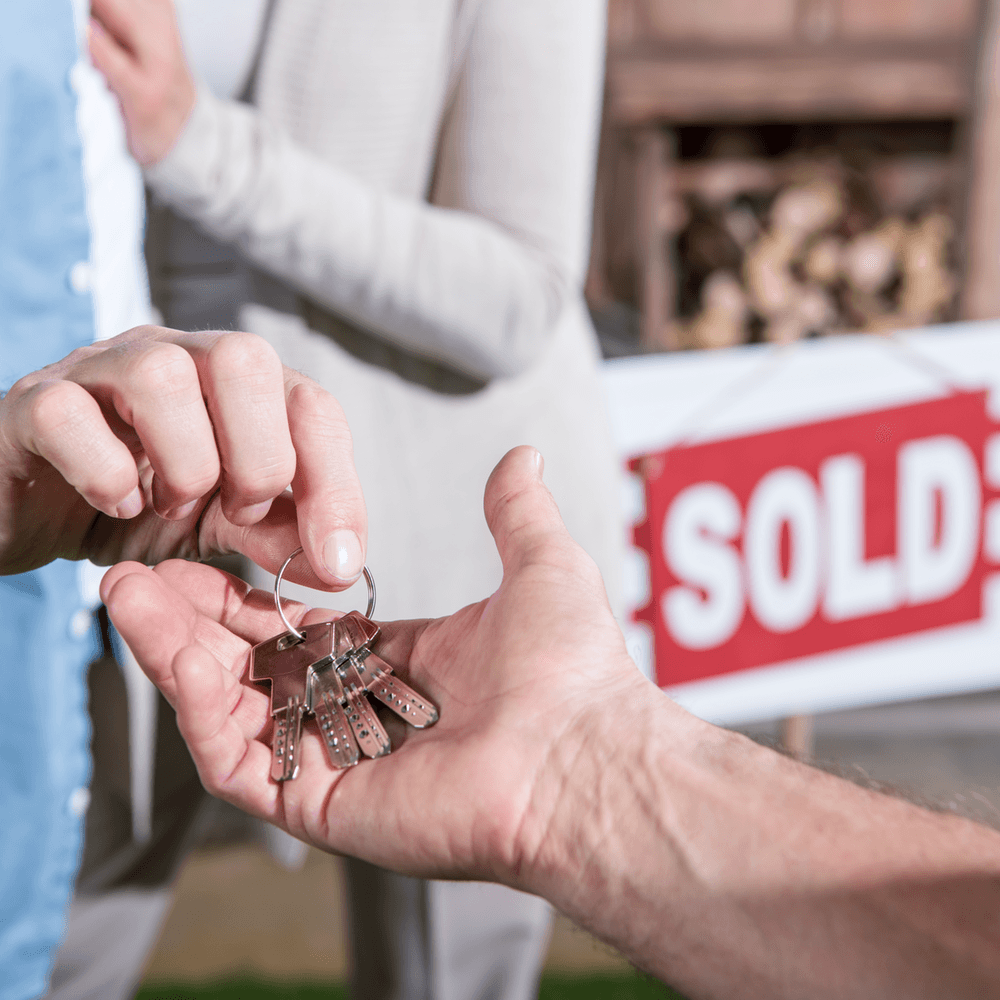 Why buying in a down market can be good for you giving keys to new owner image